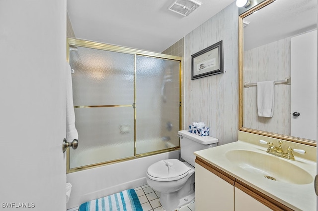 full bathroom with tile patterned floors, toilet, combined bath / shower with glass door, and vanity