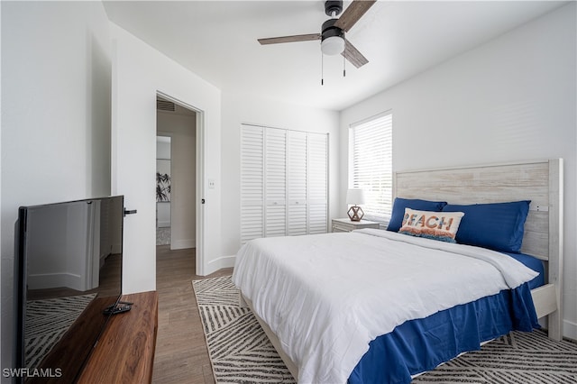 bedroom featuring hardwood / wood-style floors, ceiling fan, and a closet