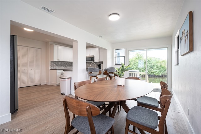 dining room with light hardwood / wood-style floors