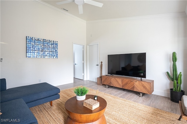 living room featuring ceiling fan, hardwood / wood-style flooring, and ornamental molding