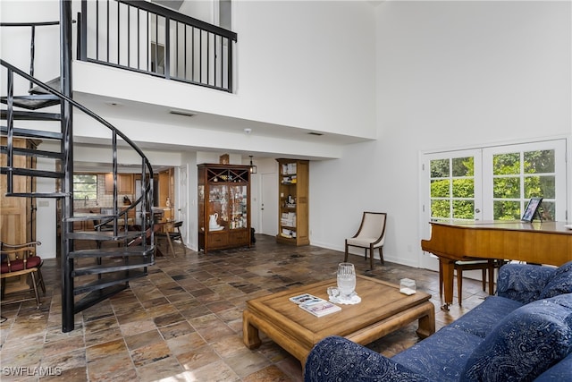 living room featuring a towering ceiling