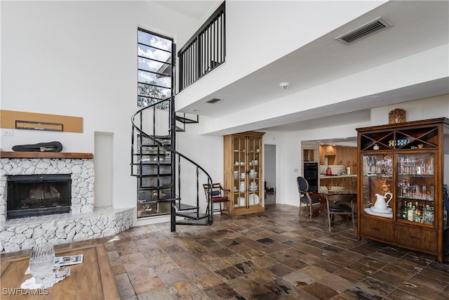 interior space featuring a high ceiling and a fireplace