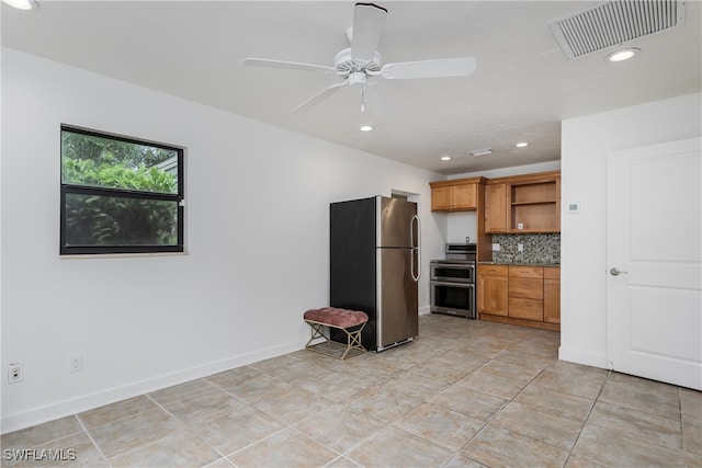 kitchen with appliances with stainless steel finishes, backsplash, light tile patterned floors, and ceiling fan