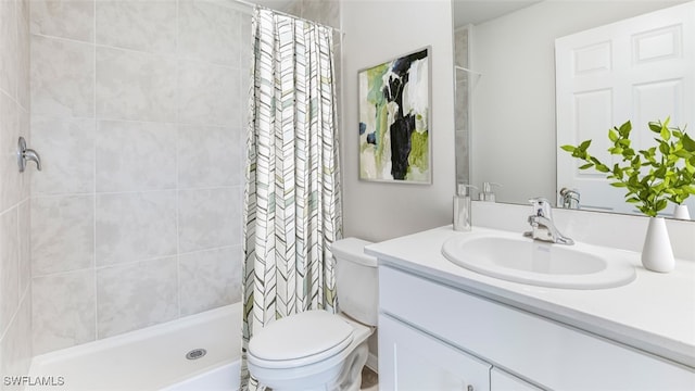 bathroom with curtained shower, vanity, and toilet