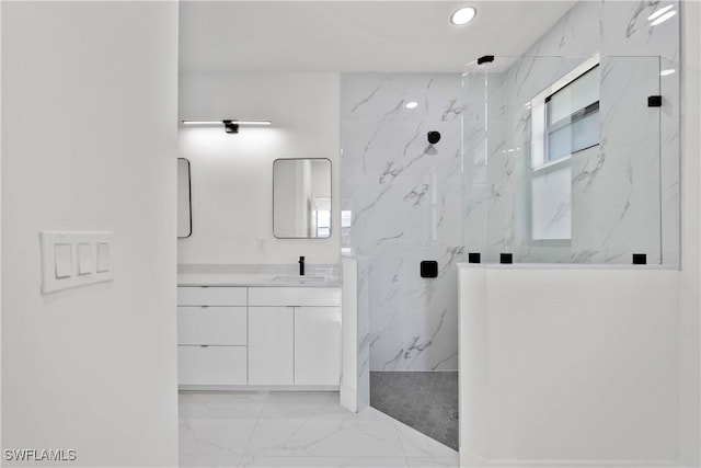 bathroom with vanity and a tile shower