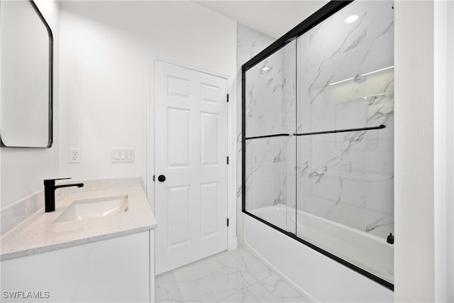 bathroom featuring enclosed tub / shower combo and vanity