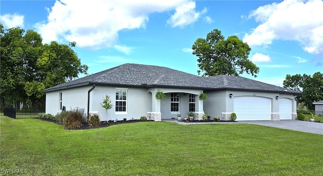 view of front of property featuring a garage and a front lawn