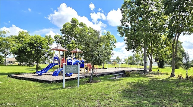 view of jungle gym featuring a lawn