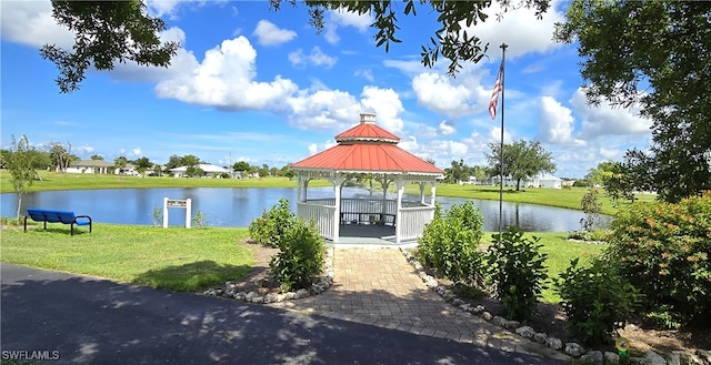 view of community featuring a water view, a yard, and a gazebo