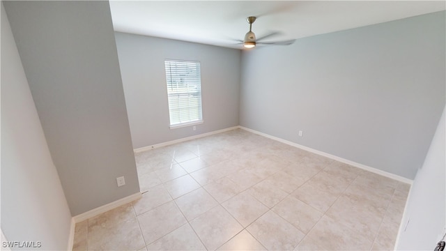 spare room featuring ceiling fan and light tile patterned flooring