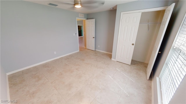 unfurnished bedroom with a closet, ceiling fan, and light tile patterned floors