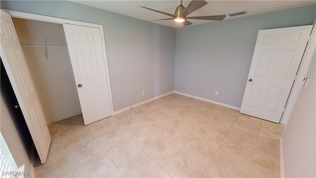 unfurnished bedroom featuring light tile patterned floors, ceiling fan, and a closet