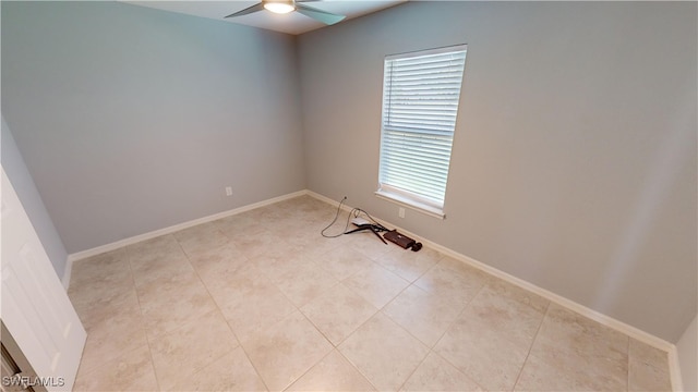 empty room featuring ceiling fan and light tile patterned floors