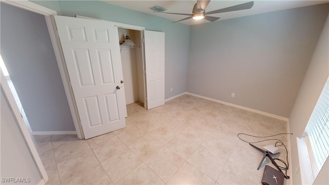 unfurnished bedroom with ceiling fan and a closet