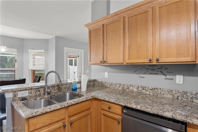 kitchen featuring light stone counters, sink, kitchen peninsula, and black dishwasher