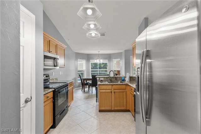 kitchen with sink, appliances with stainless steel finishes, light stone counters, decorative light fixtures, and kitchen peninsula