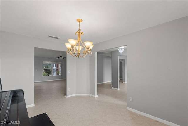 unfurnished dining area with light tile patterned flooring and ceiling fan with notable chandelier