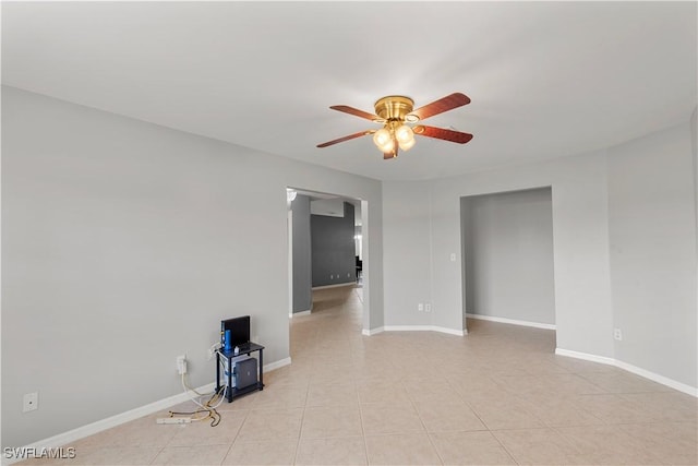 tiled empty room with ceiling fan