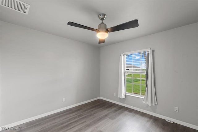 empty room featuring dark hardwood / wood-style flooring and ceiling fan