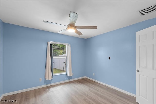 empty room with ceiling fan and light hardwood / wood-style flooring