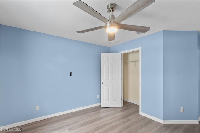 unfurnished bedroom featuring a closet, ceiling fan, and light wood-type flooring