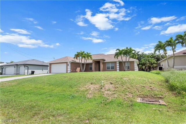 single story home featuring a garage and a front lawn