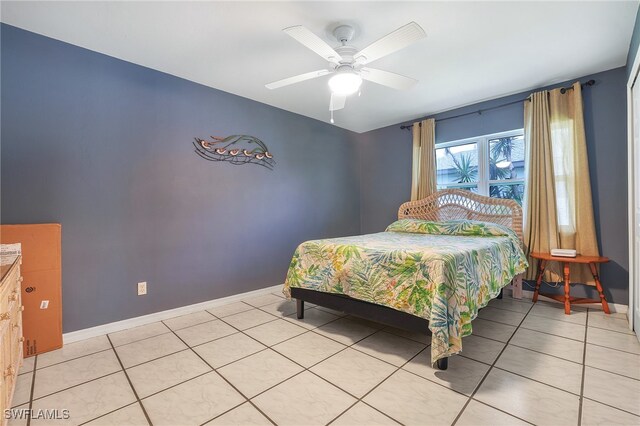 tiled bedroom with ceiling fan