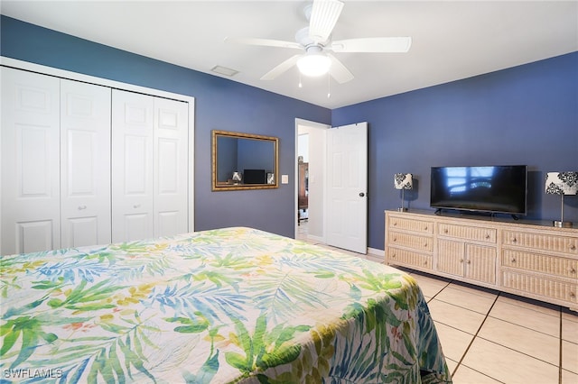 bedroom with a closet, ceiling fan, and light tile patterned flooring