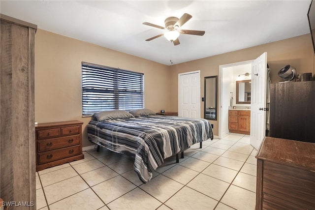 bedroom with ceiling fan, connected bathroom, and light tile patterned flooring