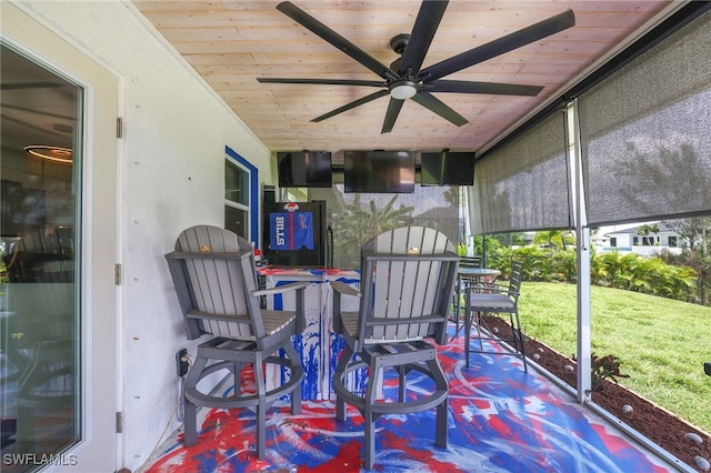 sunroom / solarium with wood ceiling and ceiling fan