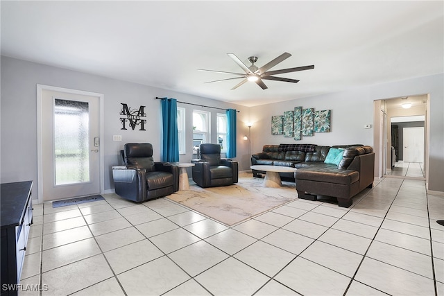 living room with ceiling fan and light tile patterned flooring