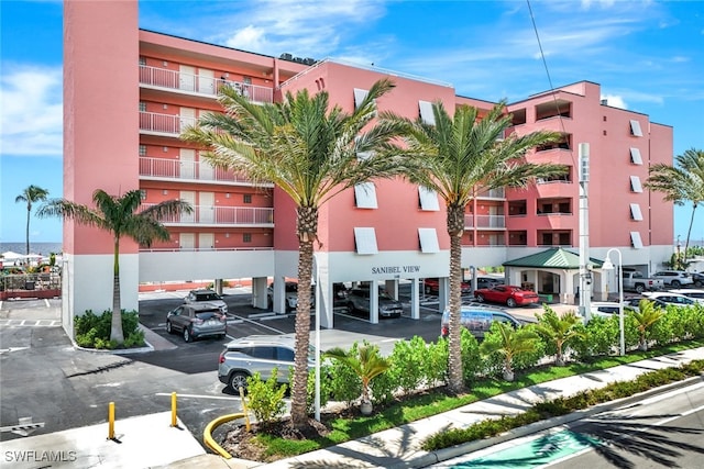 140 Estero Blvd Unit 2105, Fort Myers Beach, FL 33931 - view of property featuring covered and uncovered parking