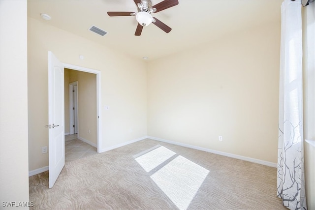 unfurnished room featuring ceiling fan and light colored carpet