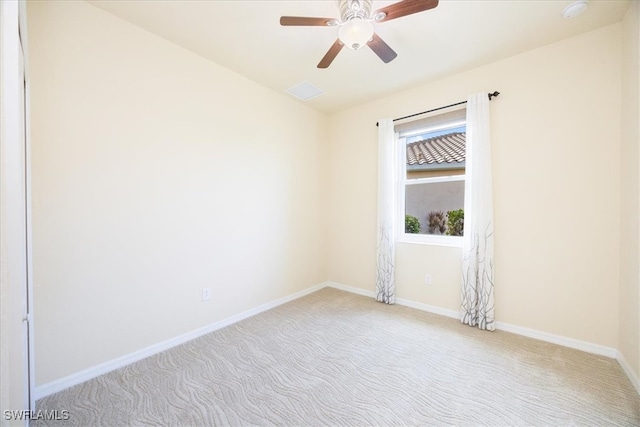 empty room featuring light colored carpet and ceiling fan