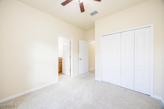 unfurnished bedroom featuring ceiling fan, light carpet, and a closet