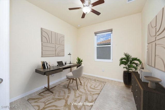 carpeted office space with ceiling fan