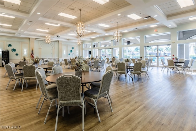 dining room with beam ceiling, a chandelier, light hardwood / wood-style floors, and coffered ceiling