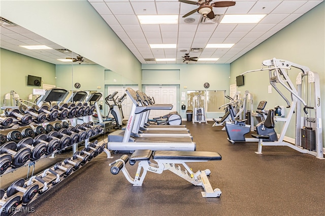 exercise room with a paneled ceiling and ceiling fan