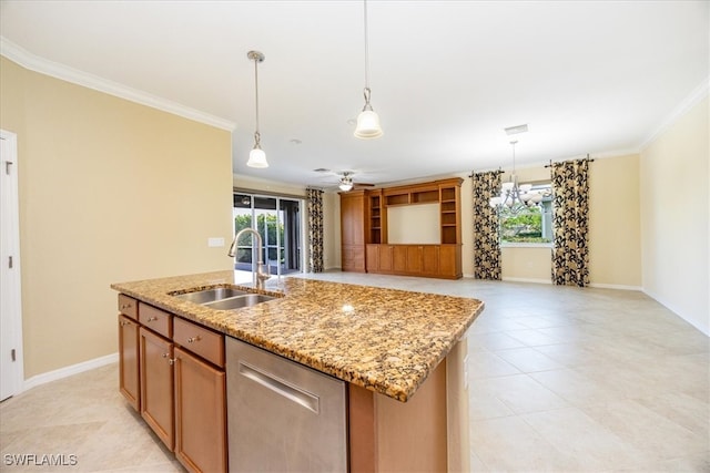 kitchen featuring a kitchen island with sink, sink, ceiling fan, and ornamental molding