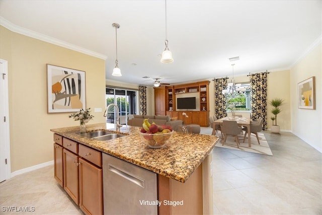 kitchen with a center island with sink, ceiling fan with notable chandelier, sink, ornamental molding, and decorative light fixtures