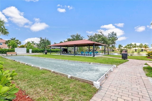 surrounding community with a gazebo, a water view, and a lawn