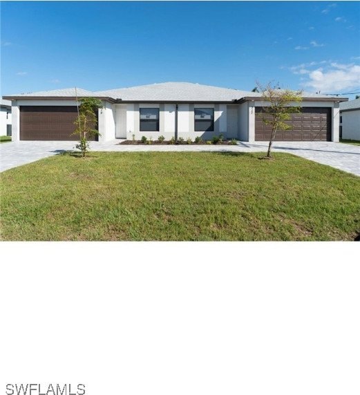 view of front facade with a garage and a front lawn