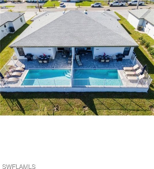 view of swimming pool with a yard and a patio area