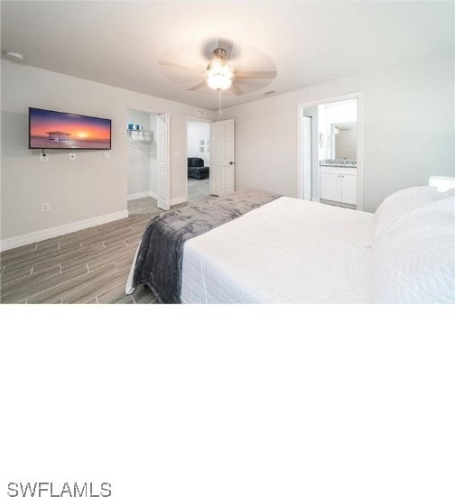 bedroom with light wood-type flooring, ceiling fan, and ensuite bathroom