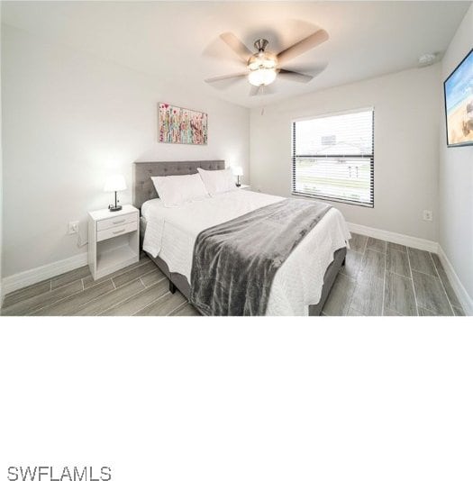 bedroom with wood-type flooring and ceiling fan