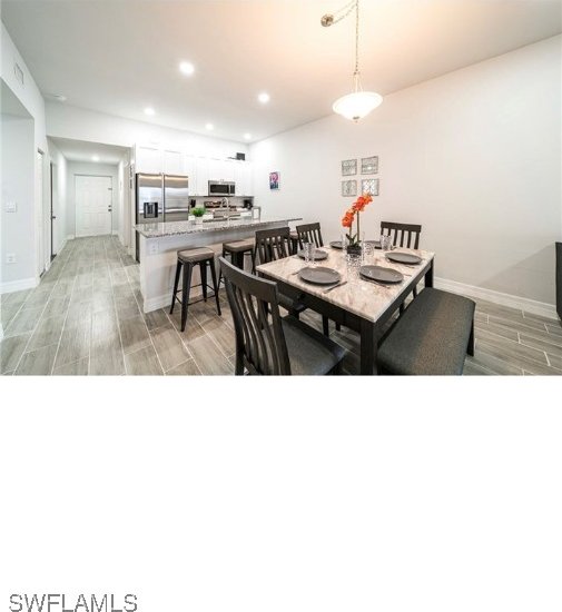 dining area with light wood-type flooring