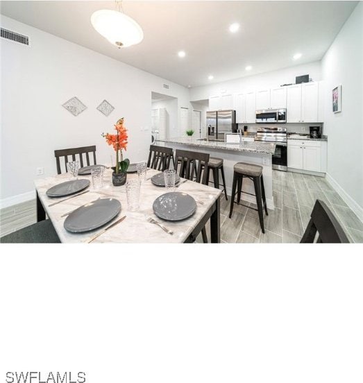 dining space featuring light hardwood / wood-style flooring