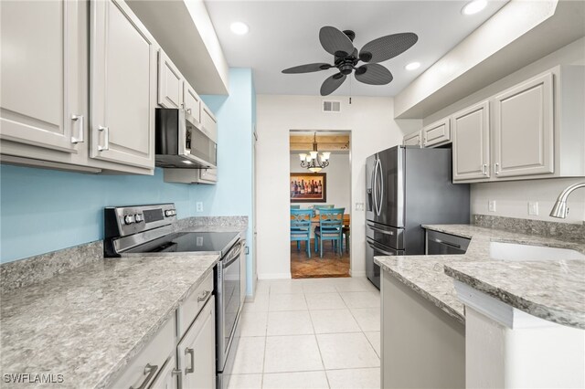 kitchen with white cabinetry, sink, light tile patterned floors, and stainless steel appliances