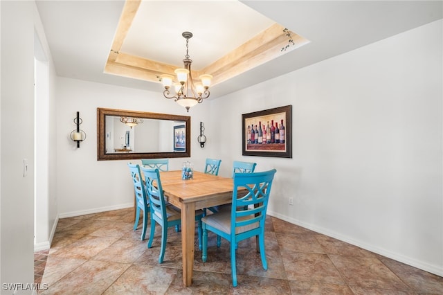 dining room featuring an inviting chandelier and a tray ceiling