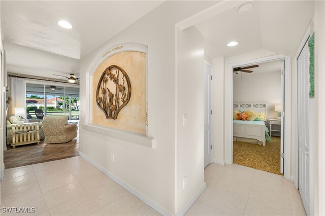 hall featuring baseboards and recessed lighting
